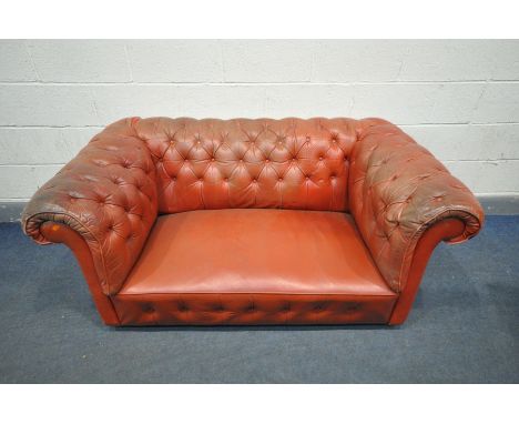 A RED LEATHER CHESTERFIELD SOFA, length 158cm (condition:-some buttons loose/missing, worn and stained armrests, ideal for re