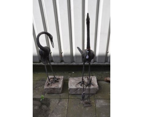 A PAIR OF METAL JAPANESE CRANE FIGURES, both figures with their necks in different positions, on a composite base, overall he