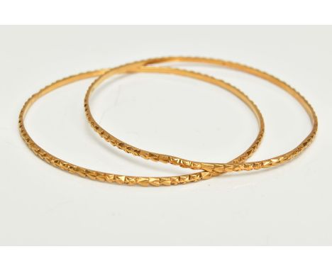 TWO YELLOW METAL BANGLES, each with embossed detail, approximate inner diameter 61mm, stamped 22c, approximate gross weight 1