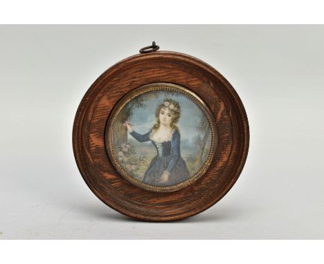 A WOODEN PORTRAIT MINIATURE, depicting a Georgian lady within a garden painting onto a tree, with glazed panel and wooden sur