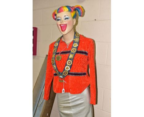 A THREE QUARTER LENGTH FEMALE SHOP MANNEQUIN ON METAL STAND, the face having a quirky expression and multi coloured hair, tog