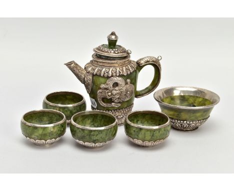 A JADE AND WHITE METAL TEA SET, of decorative oriental design, to include a tea pot with lid and dragon motif to each side, t