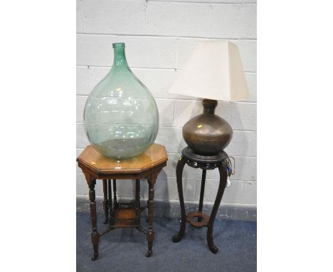 AN EDWARDIAN WALNUT CENTRE TABLE, 58cm x height 75cm, a demijohn, a mahogany torchere stand and a large metal table lamp with