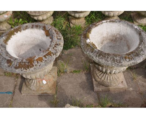 A PAIR OF COMPOSITE CAMPAGNA GARDEN URN, on a square plinth, diameter 52cm x height 56cm (condition:-partially crumbling to t