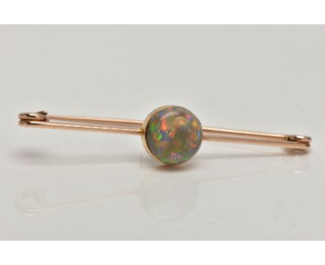 AN OPAL BAR BROOCH, a circular cut opal cabochon, extensive colour play showing flashes of green, blue, orange, red and yello