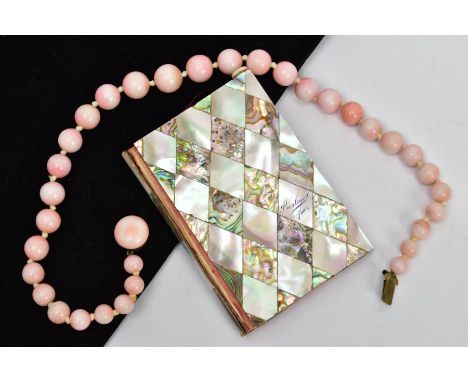 A CERAMIC BEAD NECKLACE AND AN AIDE MEMOIRE, a graduated pink glazed ceramic bead necklace, fitted with a yellow metal integr