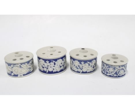 Four Staffordshire stoneware inkwells of drum form, each with four quill holes, two probably by Wilson, with floral sprig dec