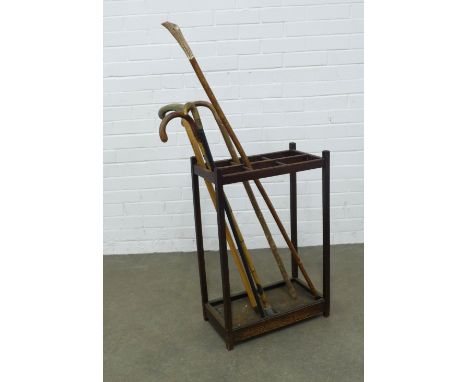 Early 20th century oak stick stand and sticks. 