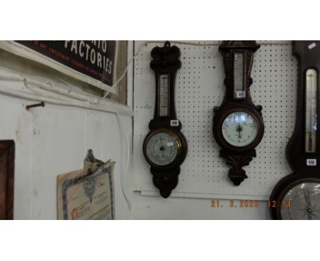 A carved oak barometer
