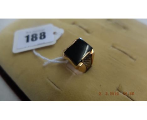 A yellow metal and onyx gentleman's ring weight 10 grams Size R