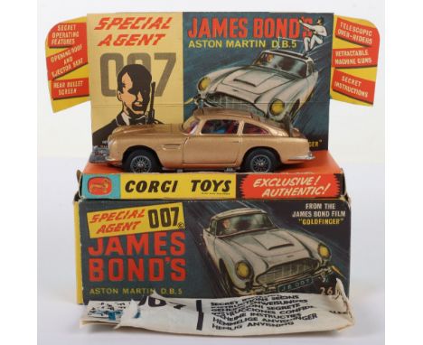 Corgi Toys 261 James Bond Aston Martin D.B.5 from the Film “Goldfinger” gold body, with working ejector seat, rear bullet scr