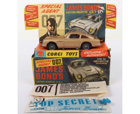 Corgi Toys 261 James Bond Aston Martin D.B.5 from the Film “Goldfinger” gold body, with working ejector seat, rear bullet scr