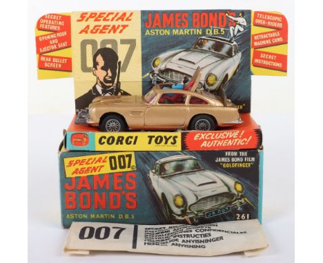 Corgi Toys 261 James Bond Aston Martin D.B.5 from the Film “Goldfinger” gold body, with working ejector seat, rear bullet scr