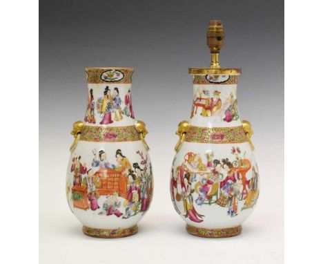 Pair of 19th Century Chinese Canton Famille Rose vases, each of footed bulbous form with gilt lion mask ring handles, painted