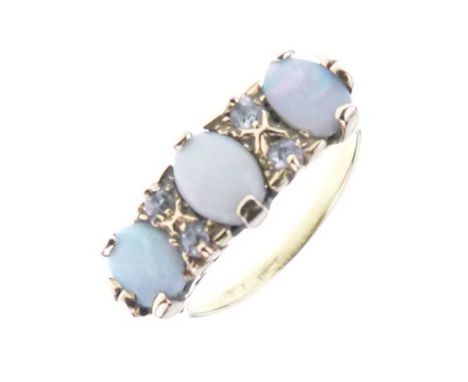 Three-stone opal ring, stamped '18ct', set with small pairs of old cut diamonds between, size M½, 4.2g gross approx