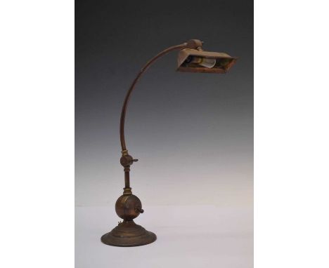 Early 20th Century lacquered gilt metal desk lamp, with adjustable shade and arm raised on globe and stepped spreading base, 