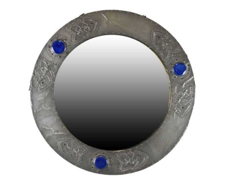 Arts & Crafts pewter wall mirror, the circular plate enclosed by pewter covered frame set with three Ruskin or Ruskin type gl