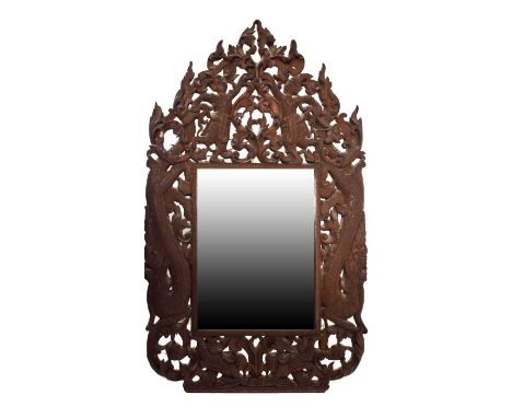 South-east Asian carved hardwood wall mirror, the bevelled plate enclosed within narrow geometric border, the outer frame car