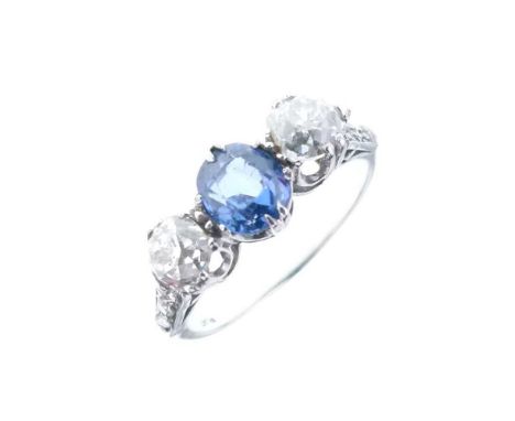 Sapphire and diamond three-stone ring, the white mount stamped 'Plat', the oval cut sapphire with an old brilliant cut to eit