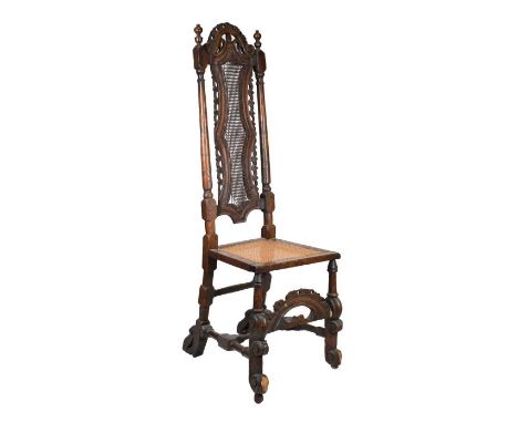 Documented late 17th Century walnut and cane high-back chair, with pierced arched foliate scroll cresting over double-waisted