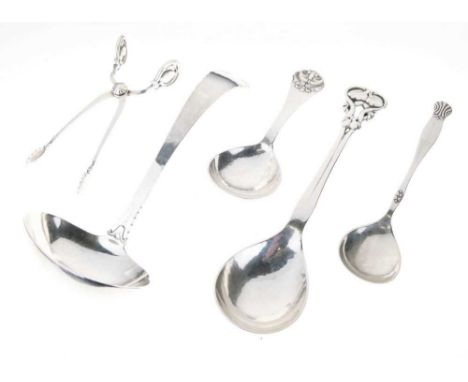 Georg Jensen silver spoon with open leaf decoration, import marks for London 1923; a Danish caddy spoon with scrollwork termi