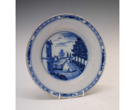 18th Century Delft plate painted with a garden landscape with canal, 23cm diameter