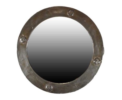 Arts &amp; Crafts pewter wall mirror, the circular plate enclosed by pewter covered fame with hammered finish and Celtic moti