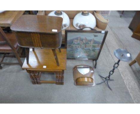 A wrought iron candle stand, oak firescreen, oak hall mirror, an oak nest of tables and a sewing table