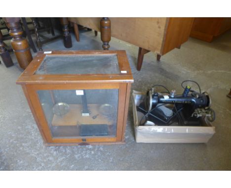 A set of chemical balance scales and a Wilcox & Gibbs sewing machine
