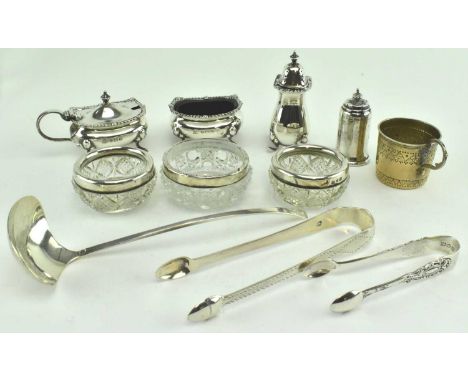 A collection of ten hallmarked silver condiment pots, jars and tongs. The lot to include three cut glass mounted wiht silver 