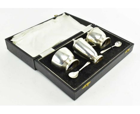 A 1970s hallmarked silver cruet set. The condiments including salt, pepper, mustard pot with original spoons. Presented in or