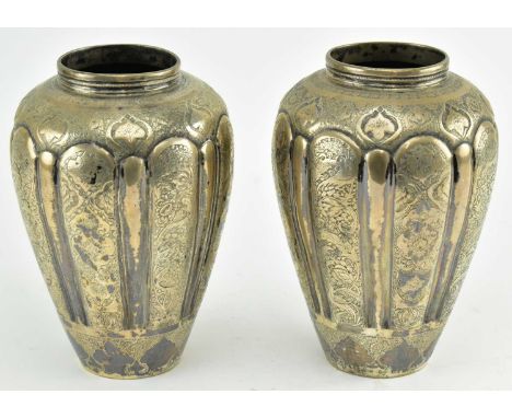 A pair of early 20th century Perisian silver vases. Each elongated ovoid shaped vase decorated with fine engraved floral and 