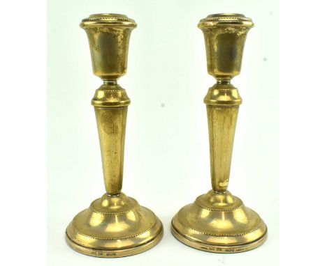 A pair of hallmarked silver filled base candlesticks. Hallmarked 1991 Birmingham. Sponsors mark for W I Broadway &amp; Co. Gr