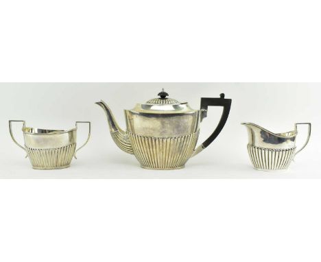 Three-piece George V silver hallmarked tea service comprising, teapot, a creamer and a twin handled sugar bowl. Hallmarked ye