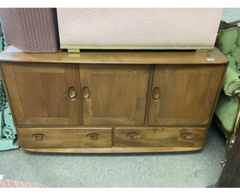 A blonde Ercol 3 door cabinet with 2 lower drawers.