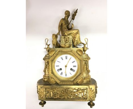 A gilt figural mantle clock with an eight day movement. Top surmounted with a seated maiden with a dog at her side plus vario