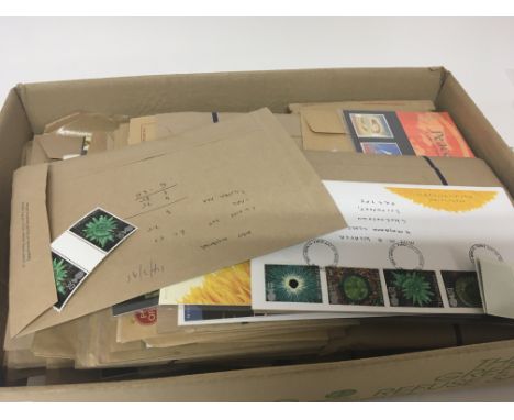 A box containing presentation pack stamps and first day covers.