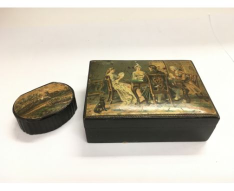 A small papier mache snuff box and a box with lid decorated with a Georgian interior scene (2).