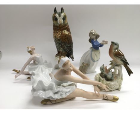 A German ceramic figure of an owl, two ballerina figures, Nao girl and a figural group of nesting birds.