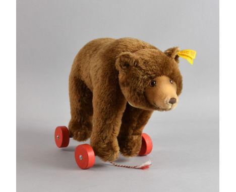 Steiff limited edition Classic brown bear on red wheels, with metal stud in ear and paper label 1938 30cm wide 21cm high