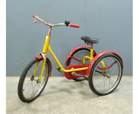 Red and yellow  Pickle child's tricycle with black saddle seat