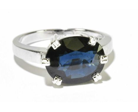 An 18ct white gold and sapphire solitaire ring with oval six claw set stone, size M 1/2, approx. 6g. 