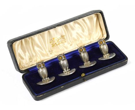 SAMPSON MORDAN; a set of four hallmarked silver novelty menu holders modelled as owls, with glass eyes, Chester 1906, approx.