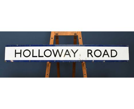 A vintage vitreous enamel railway sign, 'Holloway Road', the reverse printed V.E (S). G.17391 D.N.18466/42, length 166cm. 