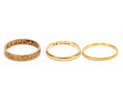 A 9ct yellow gold wedding band, size M, together with a yellow metal wedding band and 9ct gold eternity ring, approx size P, 