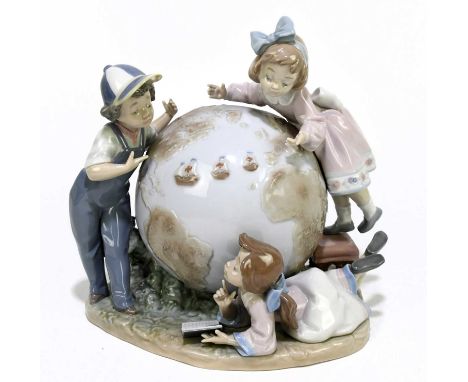 LLADRO; a figure group of children around a globe, 'Voyage of Columbus', additionally signed to the underside, height 23cm.Co