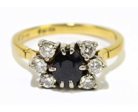 An 18ct yellow gold sapphire and diamond cluster ring with central oval sapphire within a frame of six round brilliant cut di