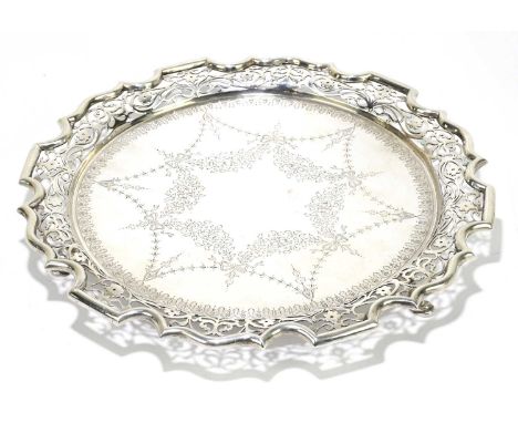 JOSIAH WILLIAMS &amp; CO; an Edwardian hallmarked and pierced silver salver, with engraved floral detailing, on three scroll 