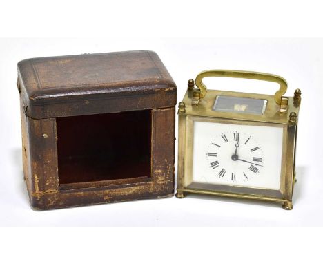 An early 20th century French brass carriage clock of rectangular form with Roman numerals to the white enamel dial and outer 