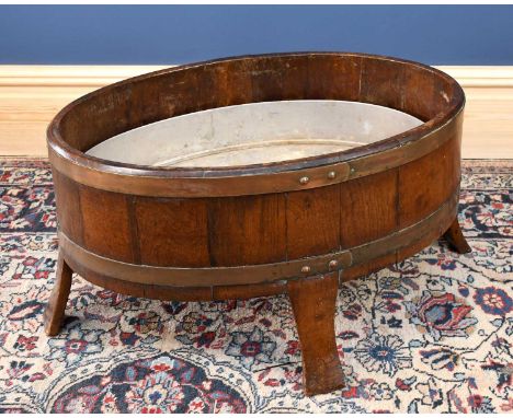 A late 19th century coppered brass bound planter of oval form, with later metal insert, width 65cm, depth 44cm, height 36cm. 